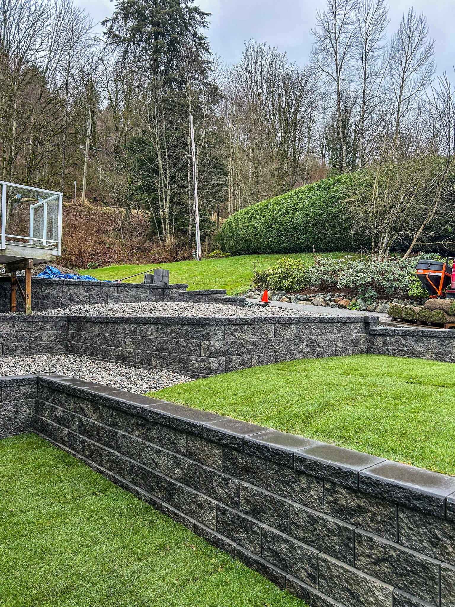 Backyard hardscaping with stone retaining walls — Chilliwack Landscaping project